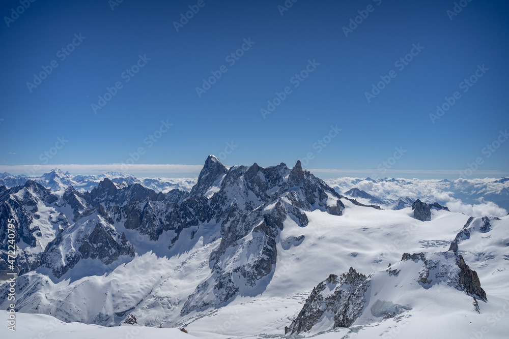 A view of the French Alps, Swiss Alps, and Italian Alps on a sunny summer day from the Aiguille du Midi near Mont Blanc in Chamonix, France