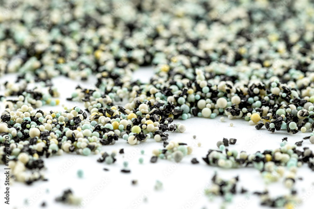 A background made out of strewn inside an activated carbon filter and water filter balls, isolated on a white background, selective focus in the center. A background made out of strewn inside an activated carbon filter and water filter balls, isolated on a white background, selective focus in the center.
