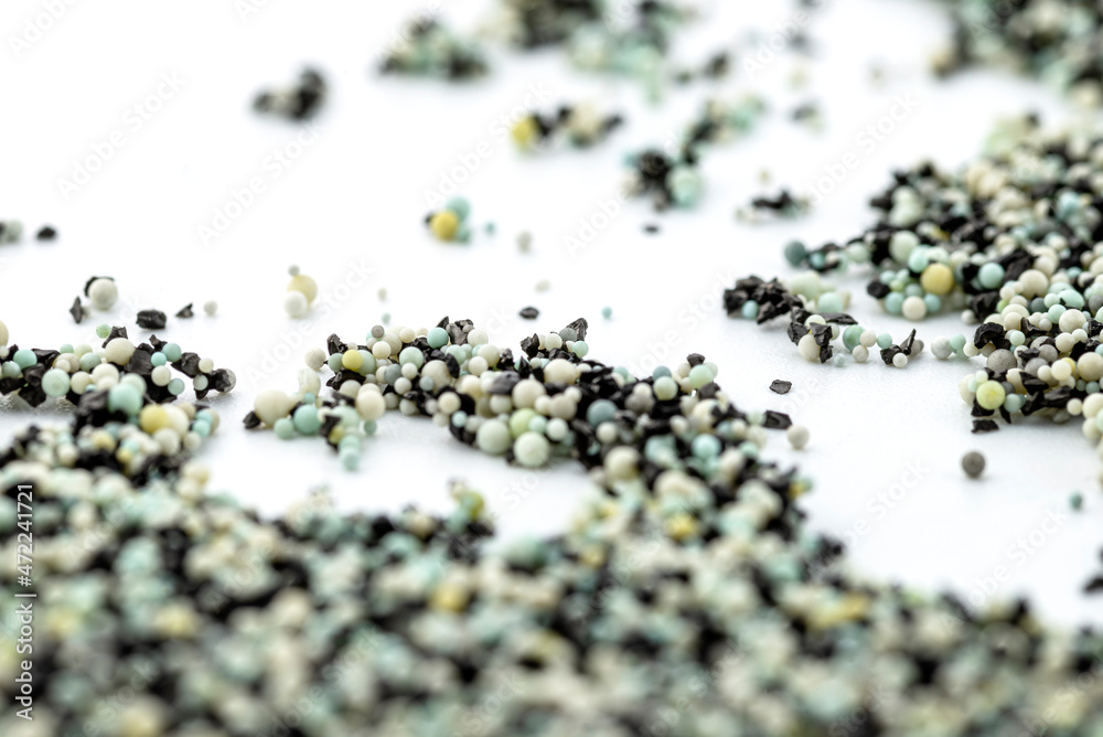 A background made out of strewn inside an activated carbon filter and water filter balls, isolated on a white background, selective focus in the center. A background made out of strewn inside an activated carbon filter and water filter balls, isolated on a white background, selective focus in the center.