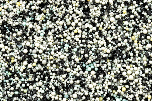 Background made from a macro photo of the inside of the filter with active carbon and water filtration pearls, top view.