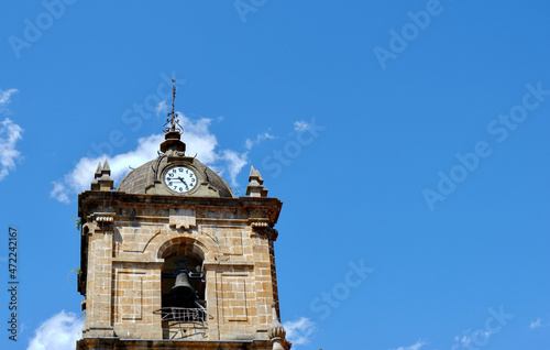 Round dome of catholic church with clock on it in Legazpi, Basque Country, Spain photo