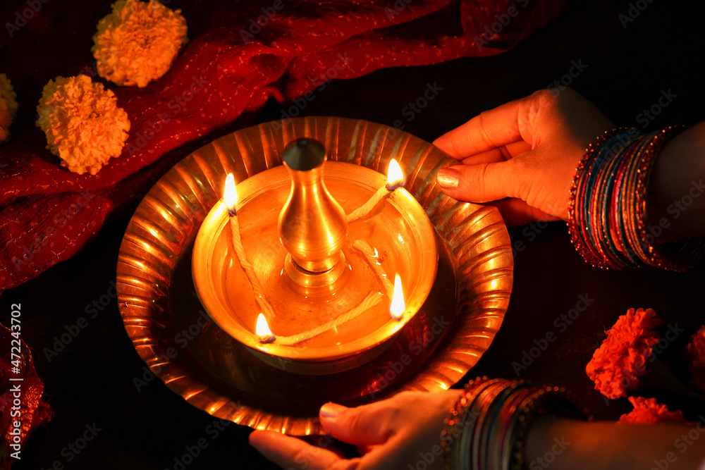 Indian woman holding lighting oil lamp Pongal Onam Diwali vishu celebration Indian festival
