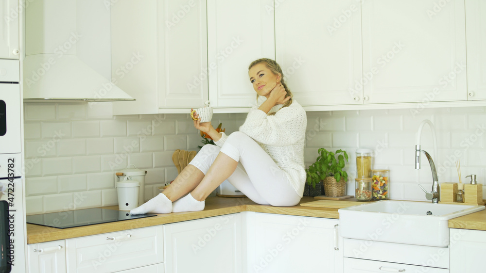 Young attractive woman relaxing with tea at home. Young attractive woman relaxing with tea at home.