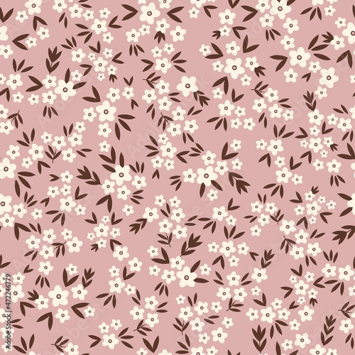 Vintage floral background. Seamless vector pattern for design and fashion prints. Floral pattern with small white flowers and brown leaves on a pink background.