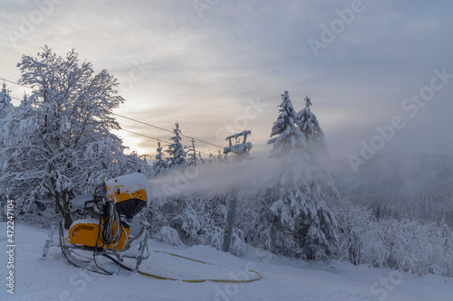 Snow cannon in winter landscape photo