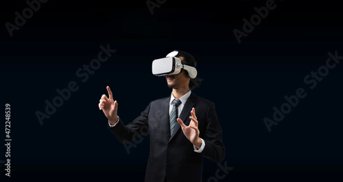 Idea. businessman wearing VR virtual reality headset hand touching virtual screen on dark background, technology, innovation, networking security, digital, internet, communication, metaverse concept