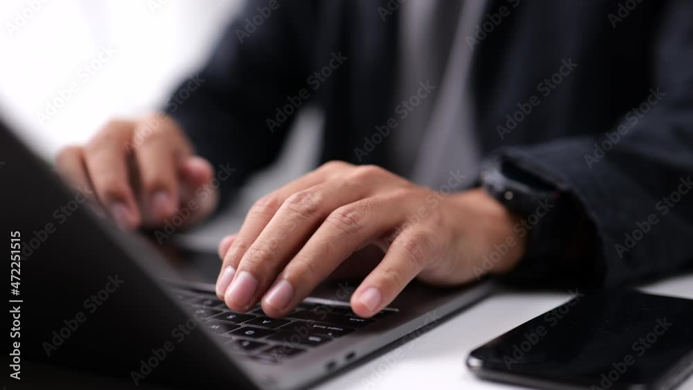 Close-up of Male hand using laptop keyboard.