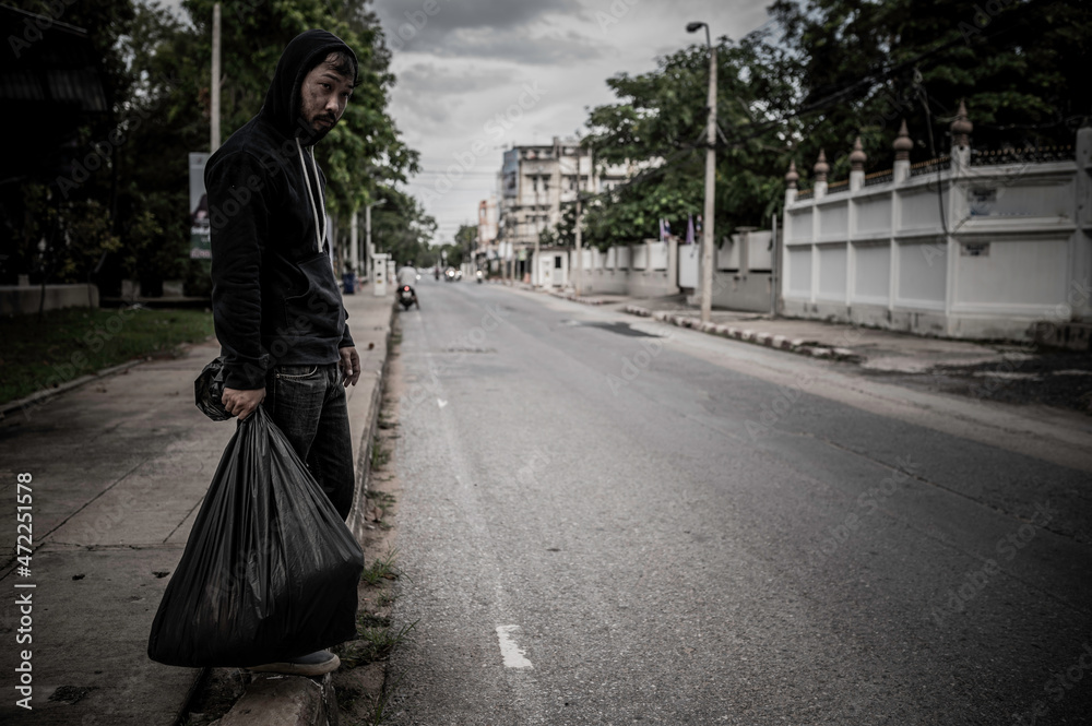 Asian man is homeless at the side road,A stranger has to live on the road alone because he has no family. Asian man is homeless at the side road,A stranger has to live on the road alone because he has no family.