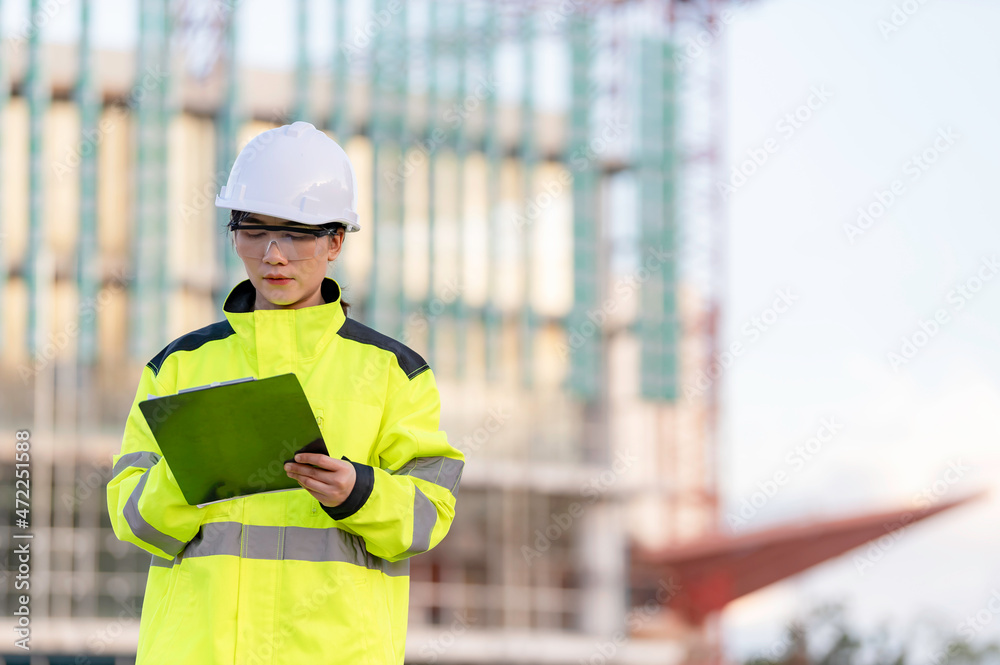Asian engineer working at site of a large building project,Thailand people,Work overtime at construction site Asian engineer working at site of a large building project,Thailand people,Work overtime at construction site