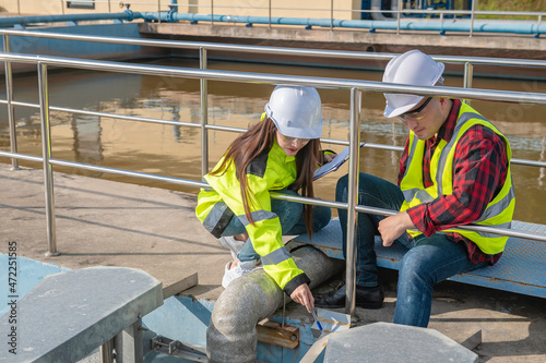 Environmental engineers work at wastewater treatment plants,Water supply engineering working at Water recycling plant for reuse,Technicians and engineers discuss work together. © reewungjunerr