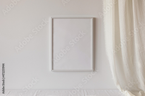 White photo frame mockup on white wall