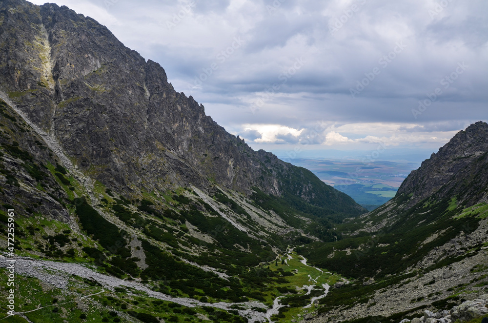 Amazing landscape with majestic rocky mountains under low grey sky in High Tatras, Slovakia