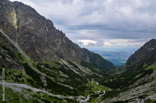 Amazing landscape with majestic rocky mountains under low grey sky in High Tatras, Slovakia