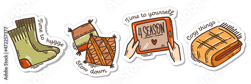 Colorful hand-drawn cold days mood stickers set with a blanket and pillow, and wooly socks and the favorite series in doodle style and lettering isolated on white background.