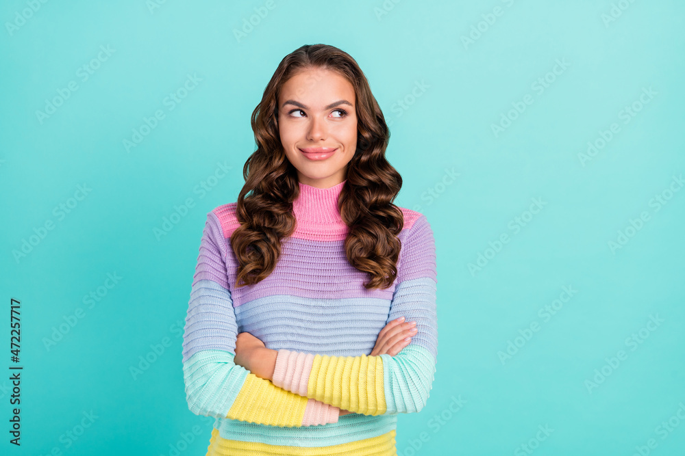 Photo of pretty brunette millennial lady crossed arms look empty space wear striped pullover isolated on teal color background