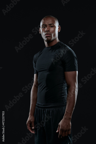 Fotografie Young serious athletic black man looking at camera