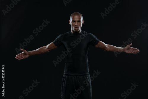 Fotografie Young athletic black man with outstretched hands