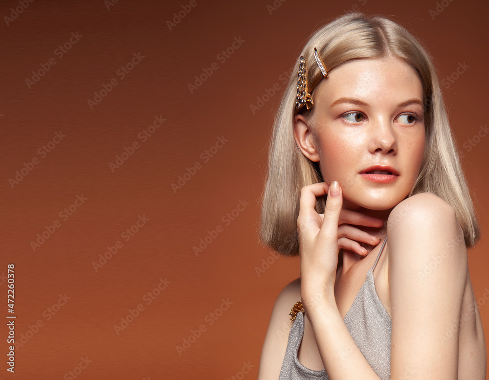 young pretty girl with blond hair posing cheerful on brown background, lifestyle people concept young pretty girl with blond hair posing cheerful on brown background, lifestyle people concept