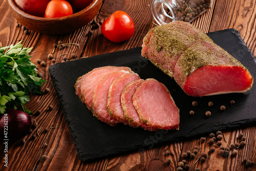 homemade dried meat on a background with vegetables