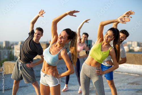 Group of fit healthy friend, people exercising together outdoor