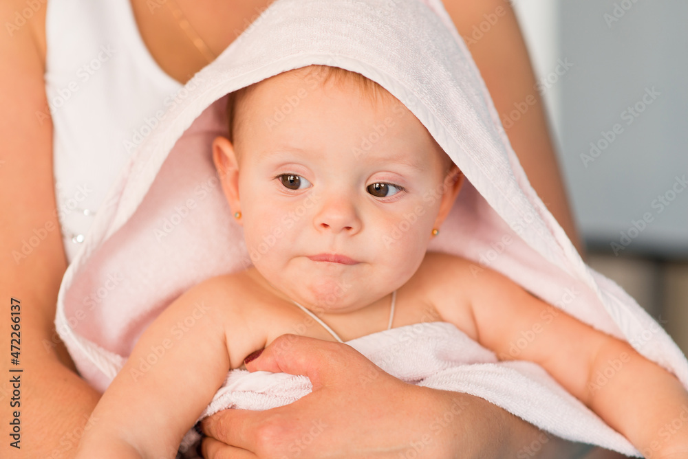 Mom and baby. The baby is wrapped in a towel after the bath. Mom and baby. The baby is wrapped in a towel after the bath.