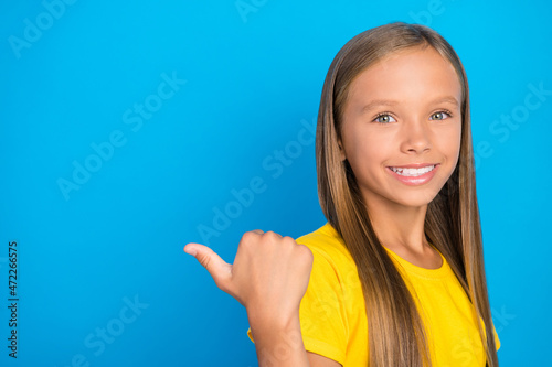 Photo of cheerful lady direct finger empty space novelty sale wear yellow t-shirt isolated blue color background