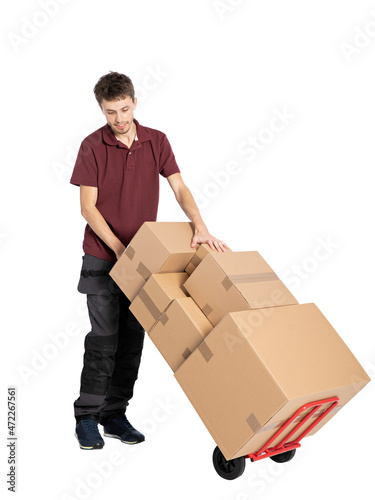 Delivery man with parcels . Handsome happy young delivery man holding cardboard boxes and smiling at camera isolated on white © wip-studio