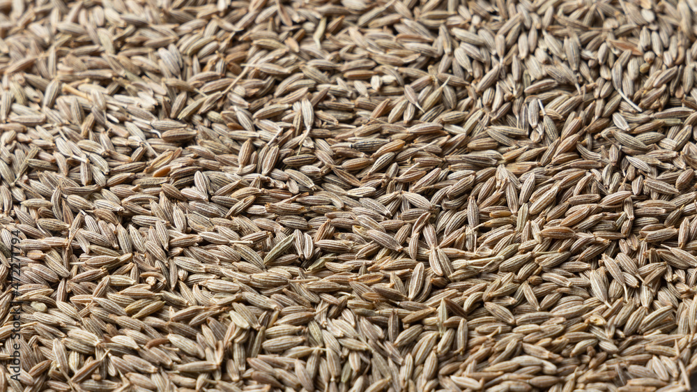Pile of cumin seeds as background. Perspective view