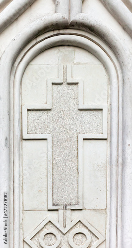 Christian cross on building wall.