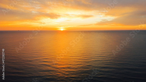 Beautiful sunset over sea, aerial view. Evening seascape, drone photography. © Iryna