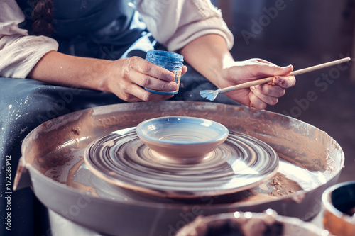 Creating a jar or vase. Master crock. Making clay jug. The sculptor in the workshop makes a jug out of earthenware closeup. Potter's wheel. Pottery concept.