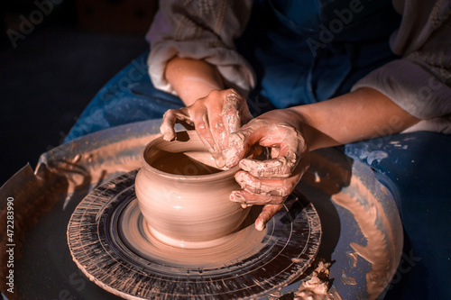 Craftsman master making ceramic pottery on wheel. Making ceramic dishes. Close-up. photo