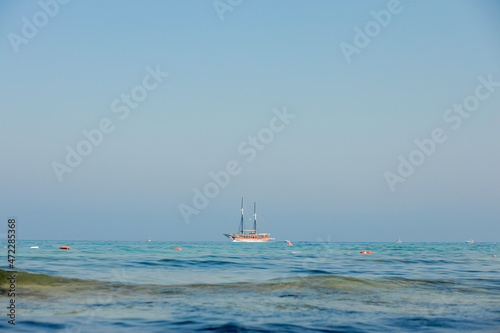 A cruise ship sailing on the sea. Travel by ferry. Sea cruise on a ship. Blue seascape with ship. Sea voyage © volody10