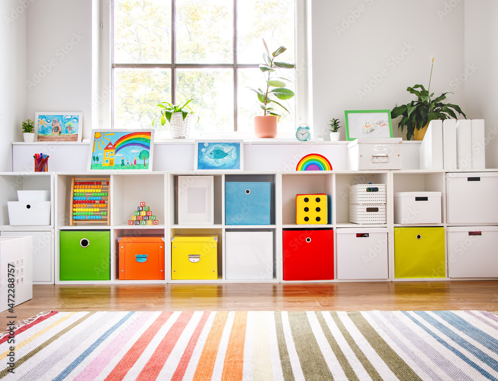 White nursery room with shelves and colourful boxes. - obrazy, fototapety, plakaty 