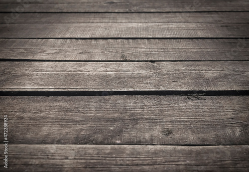 Wood rustic background with dark old dirty planks. Wooden grunge floor in perspective and vignette.