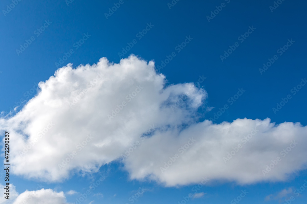 Blue sky with white fluffy clouds. Background image of the sky and clouds. Blue sky with white fluffy clouds. Background image of the sky and clouds.