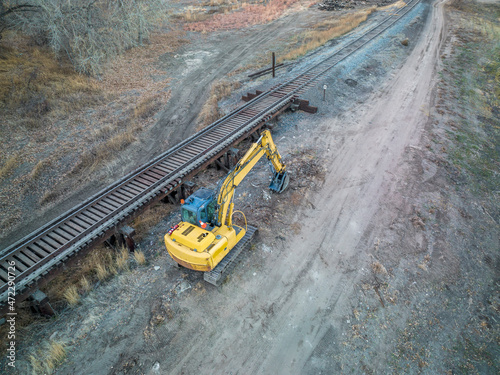 backhoe excavator and railroad track and trestle - aerial view in fall scenery Fototapeta