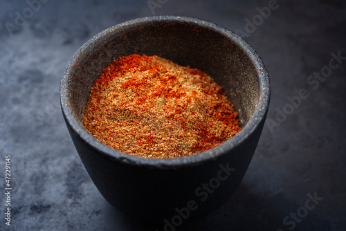 Fototapeta Naklejka Na Ścianę i Meble -  Traditional fine grinded rub for barbecue pulled beef and pork offered as close-up in a rustic bowl with copy space