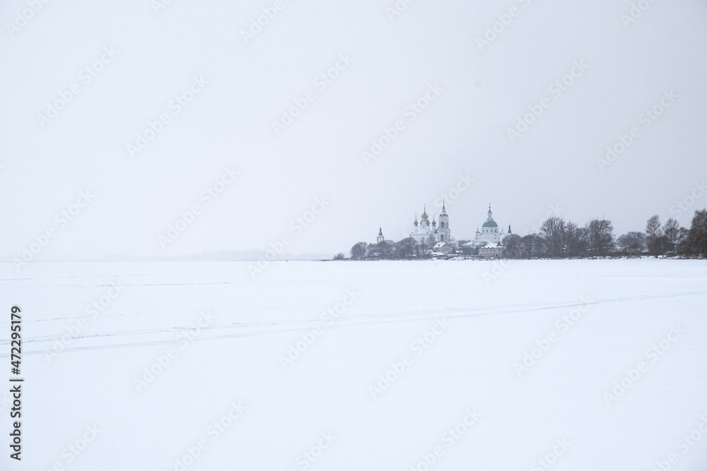 Fototapeta premium Frozen lake in the snow. Temple Monastery. Rostov