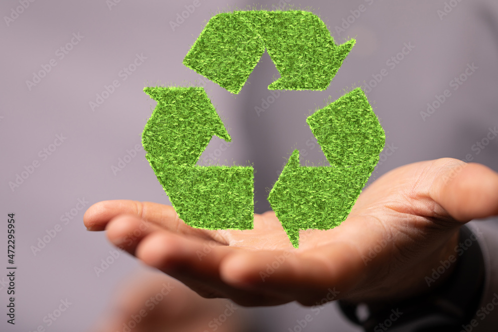 hand holding green recycle symbol hand holding green recycle symbol