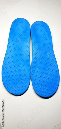 Individual orthopedic insoles for shoes in blue. Children's insoles for foot correction. Medical insoles.