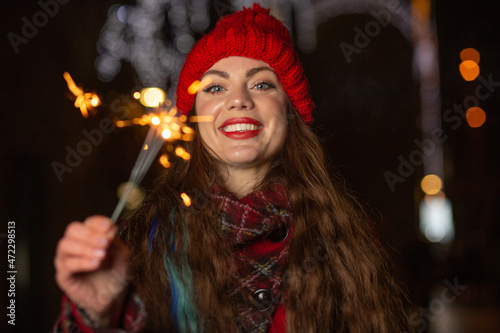 Cheerful lady having fun with sparklers