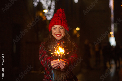 Merry lady having fun with sparklers