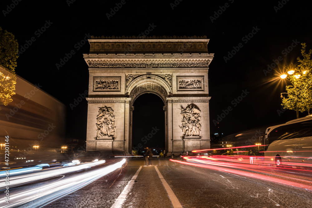 Nightly traffic on the Champs-Elysees, Arc de Triomph in the background Nightly traffic on the Champs-Elysees, Arc de Triomph in the background