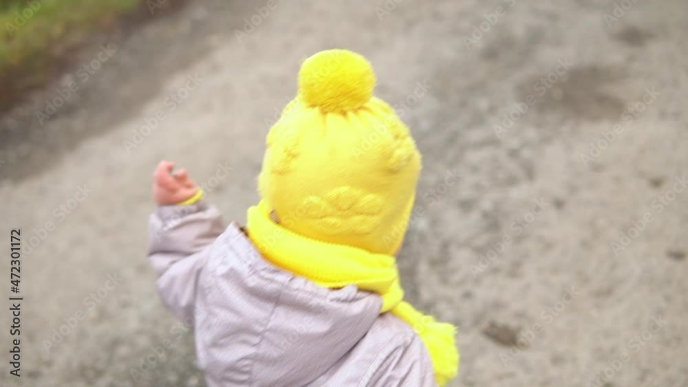 baby runing. little girl in grey jumpsuit yellow hat walking through forest park path. kid dream funny family concept. Toddler outside. fun happy childhood carefree Children walk child in yard baby runing. little girl in grey jumpsuit yellow hat walking through forest park path. kid dream funny family concept. Toddler outside. fun happy childhood carefree Children walk child in yard