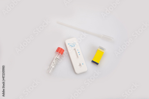 isolated shot of a new blank rapid express antigen antibody coronavirus covid-19 pandemic test sample, blood collector pastette, lancet vial, solution, packages on white background