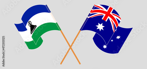 Crossed and waving flags of Kingdom of Lesotho and Australia
