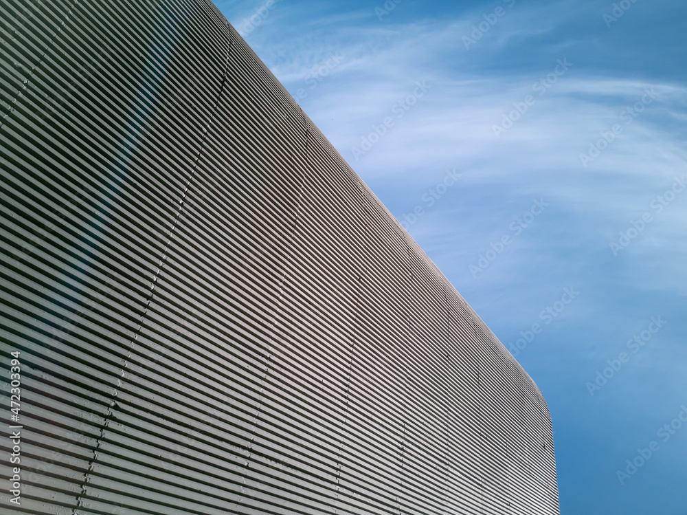 Architectural detail in apparent cement building with blue sky.