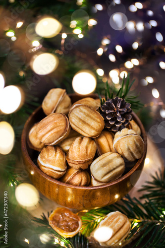 Homemade Russian cookies "Nuts" with boiled condensed milk filling on a holiday background