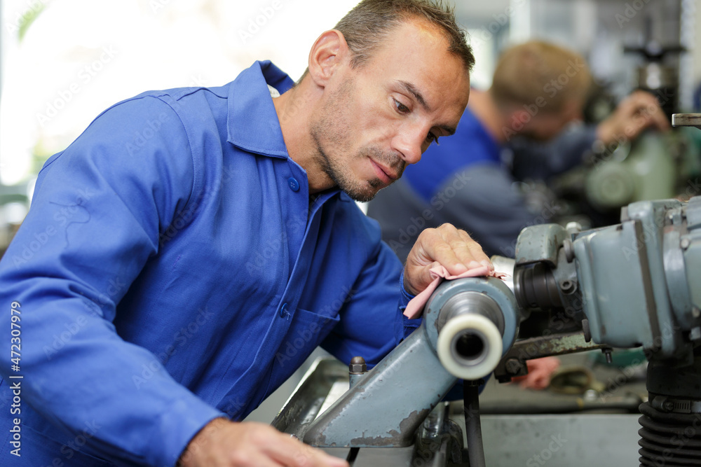 engineer maintaining machinery in factory